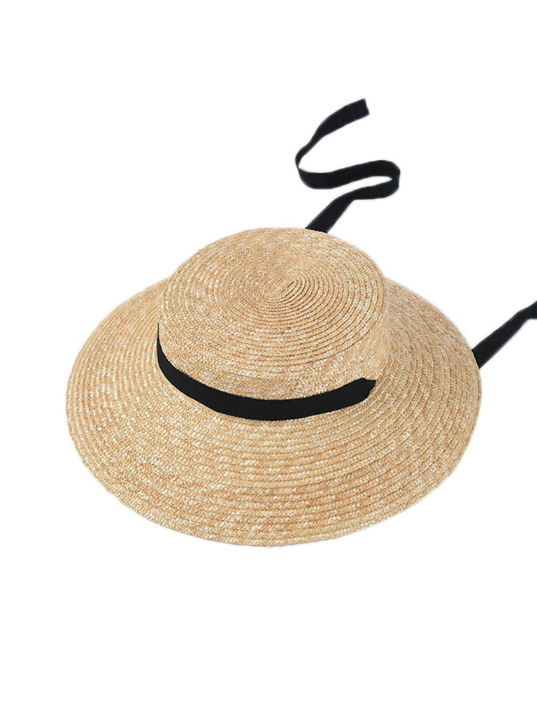 Cappello in rafia intrecciata con nastro nero