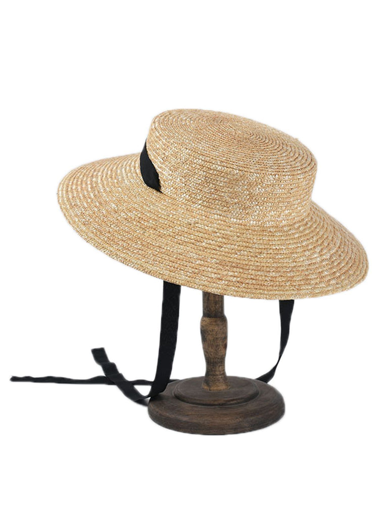 Cappello in rafia intrecciata con nastro nero