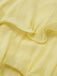 Close-up of light yellow fabric with ruffled edge