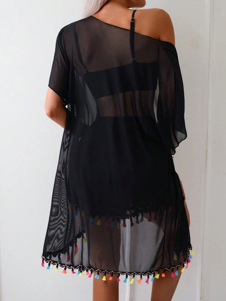 Black off-shoulder dress with colorful tassels on a plain background