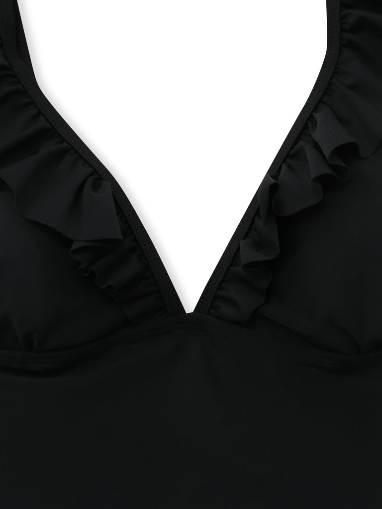 Black swimsuit with ruffled details on a white background