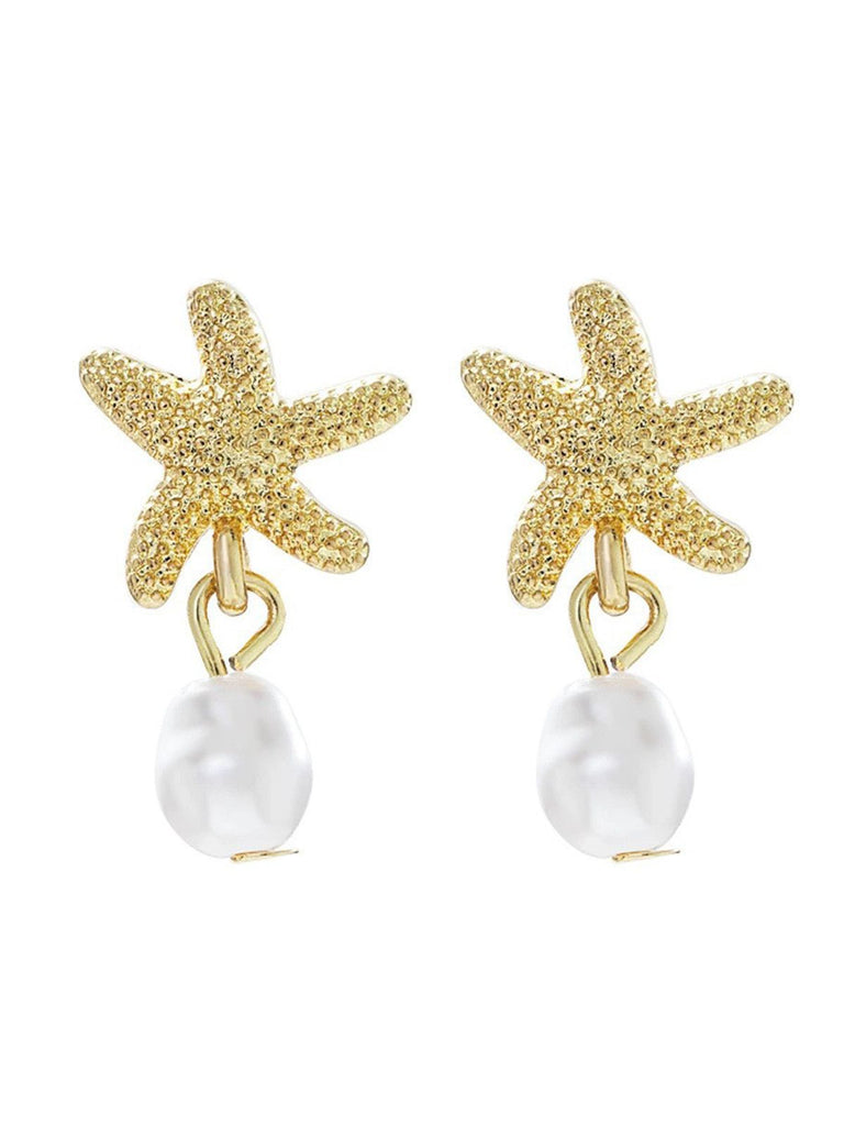 Gold starfish earrings with pearl drops on a white background