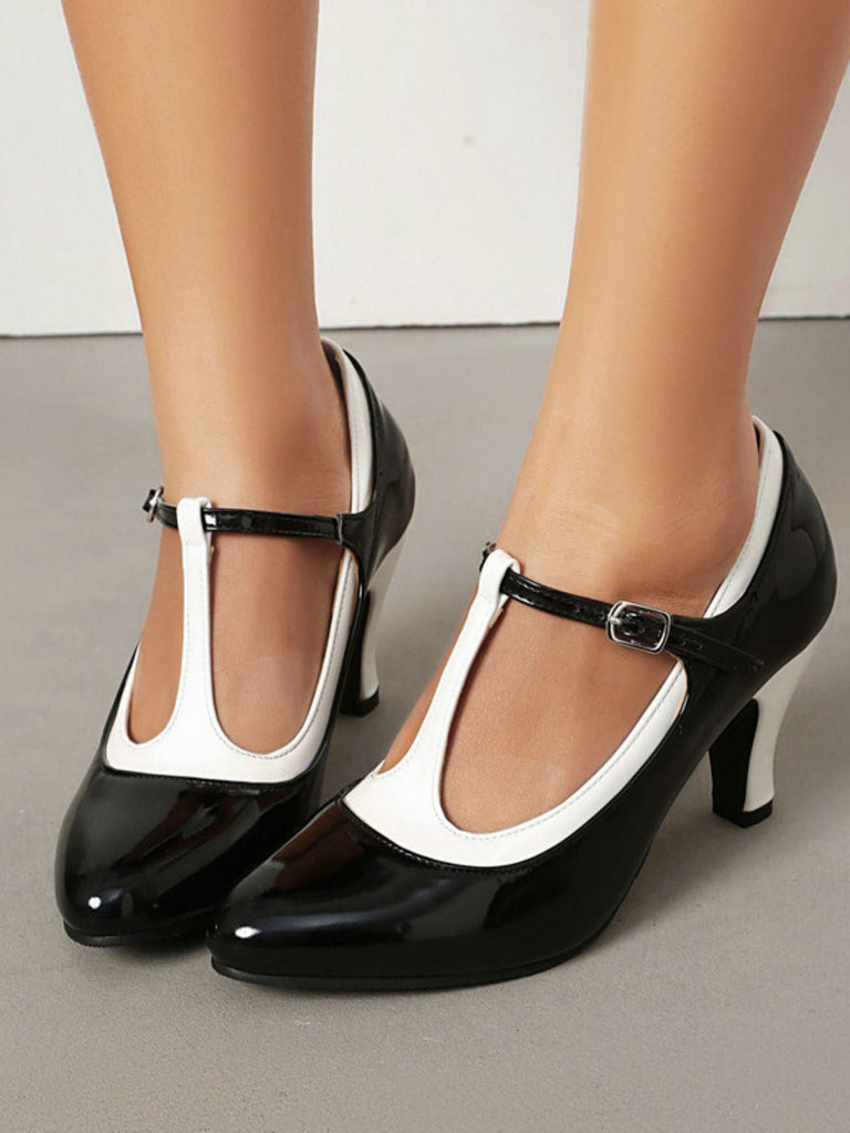 Black and white high-heeled shoes on a neutral background