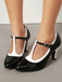 Black and white high-heeled shoes on a neutral background