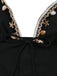 Black dress with white lace trim and shell embellishments on a white background