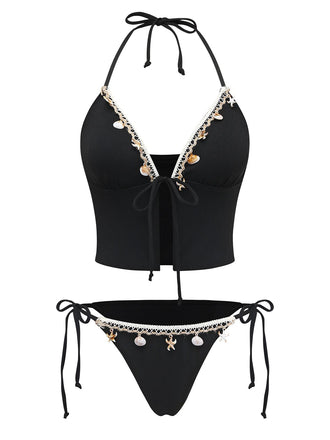 Black bikini set with decorative elements on a white background