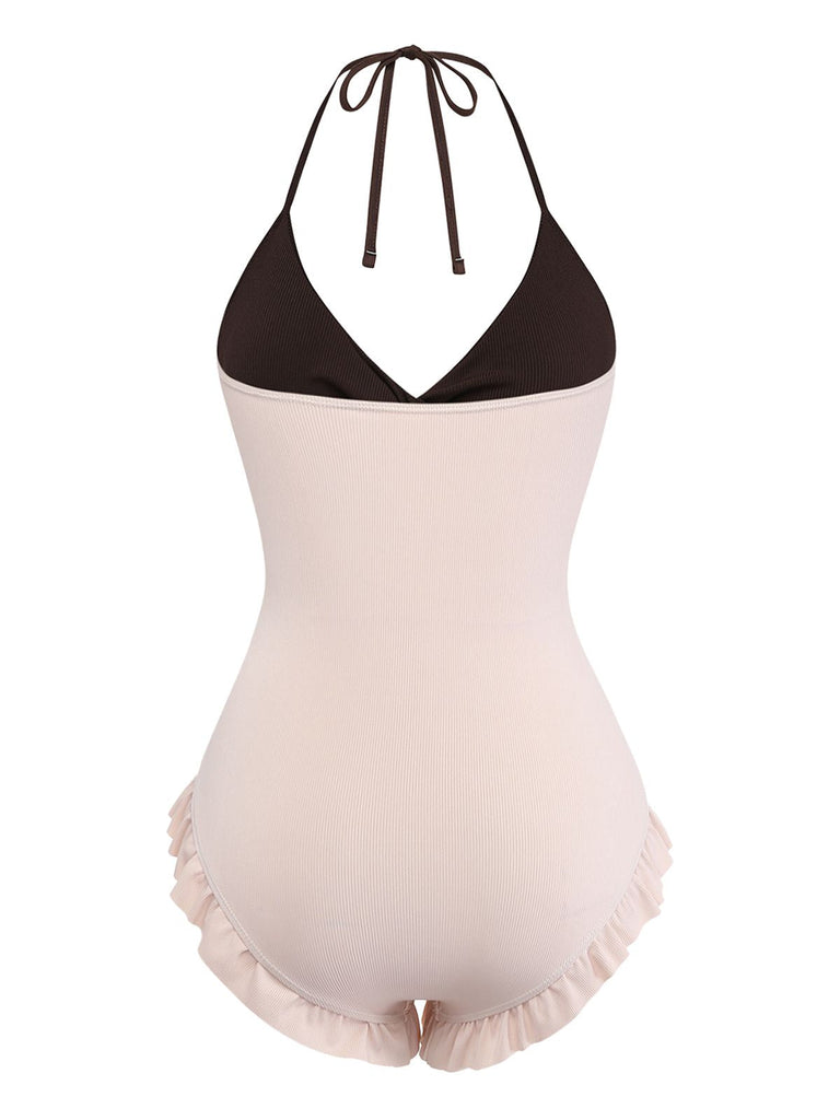 One-piece swimsuit with black top and beige bottom on a white background