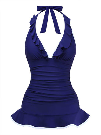 Vista frontale della versione blu navy del costume da bagno con scollo all'americana e volant, che mette in risalto il tessuto arricciato che modella la pancia.