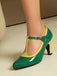 Green and yellow high-heeled shoes on a neutral background
