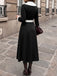 Abito anni '50 nero e bianco con revers e scollo a V e maniche lunghe 5