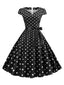Abito a pois con maniche a cappuccio e cintura anni '50