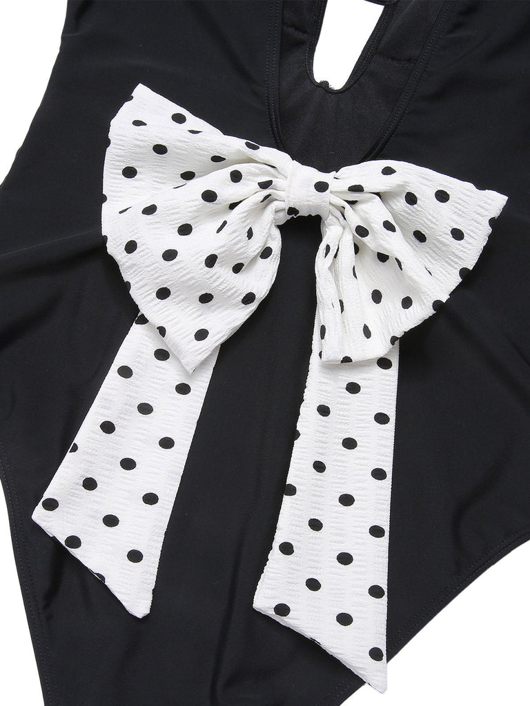 Costumi intero a pois fiocco e scollo a V nero anni '50