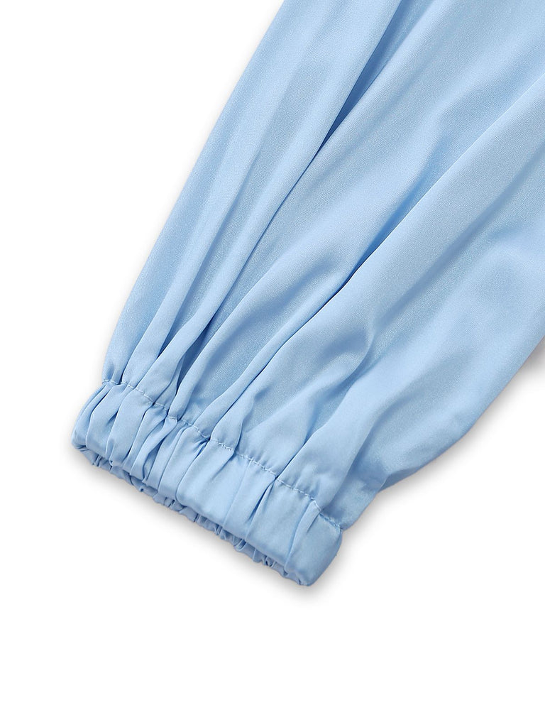 Detailed shot of the voluminous balloon sleeve and its gathered elastic cuff on the silky lounge top.