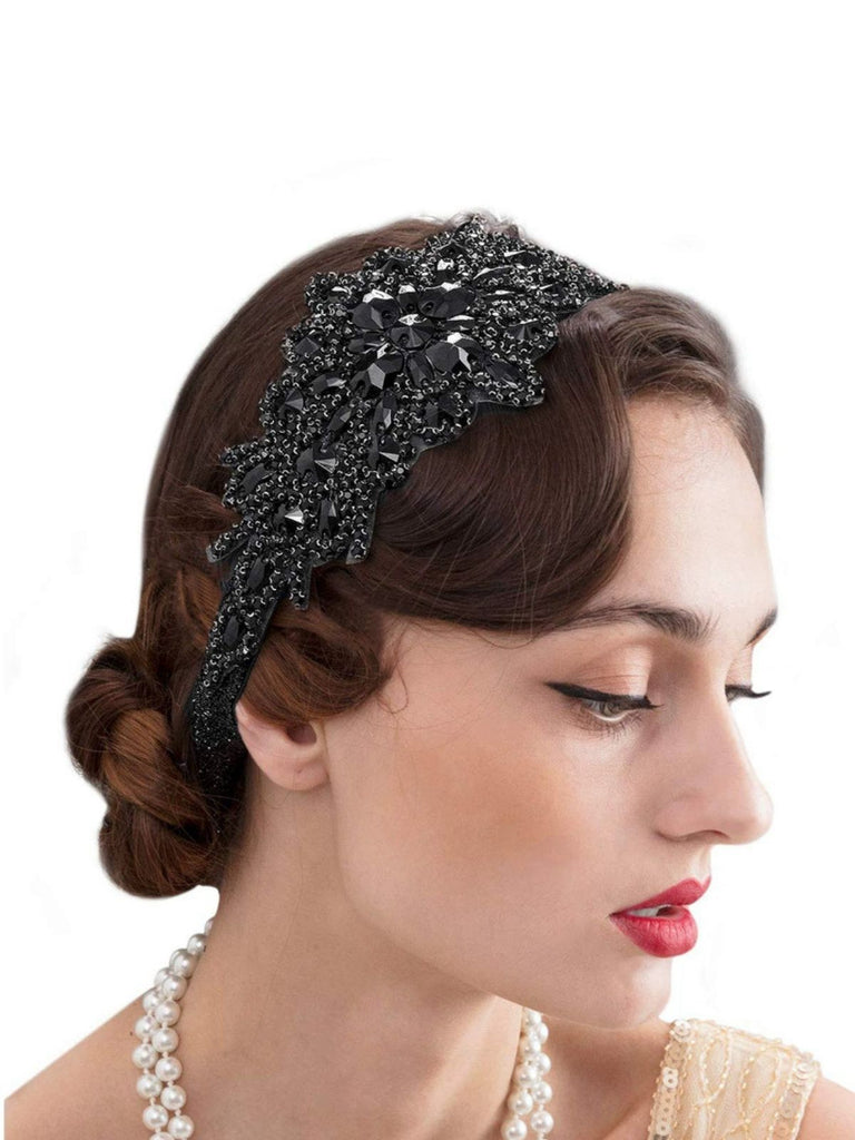 Woman wearing a decorative black headband with crystals on a white background