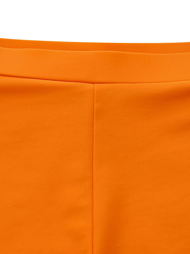 Macro view of the comfortable elastic waistband and smooth stretch fabric of the orange floral bikini shorts.