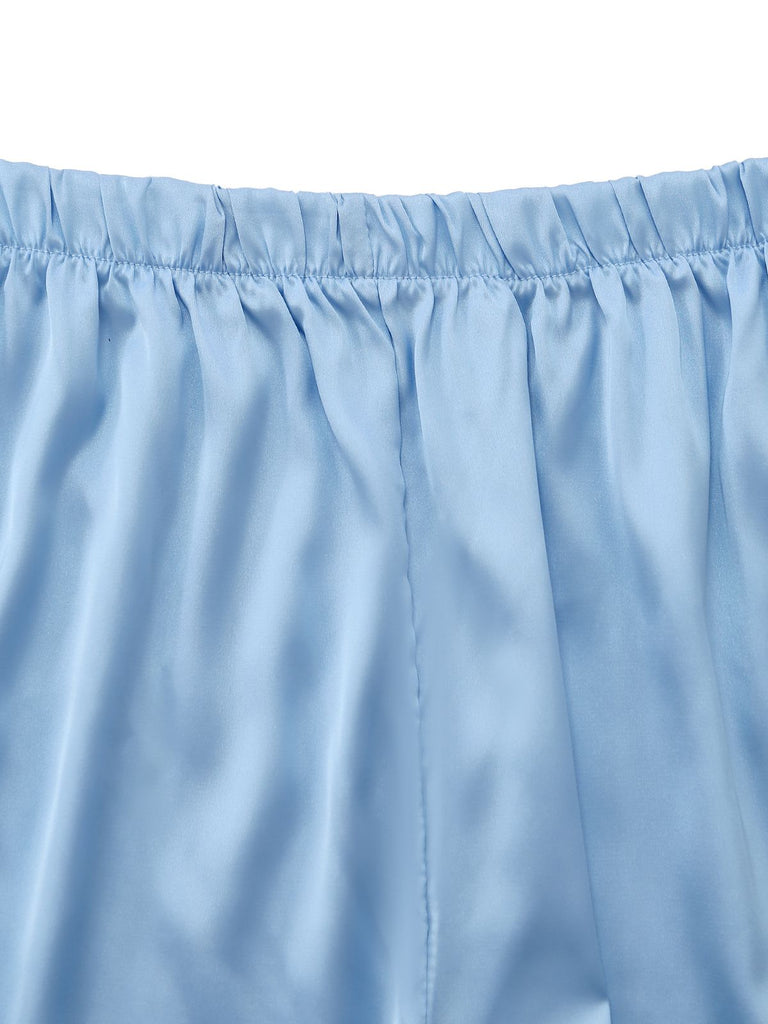 Close-up of the stretchy elastic waistband and fine stitching on the silky satin shorts.