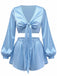 A light blue silky satin two-piece lounge set featuring a cropped tie-front top with long balloon sleeves and matching high-waisted shorts.
