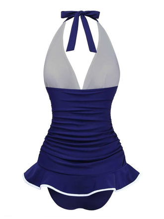Back view of the navy blue skirted swimsuit, showing the comfortable fit and elegant silhouette.