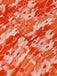 Close-up of orange and white floral fabric texture