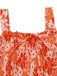 Orange and white floral patterned top on a white background