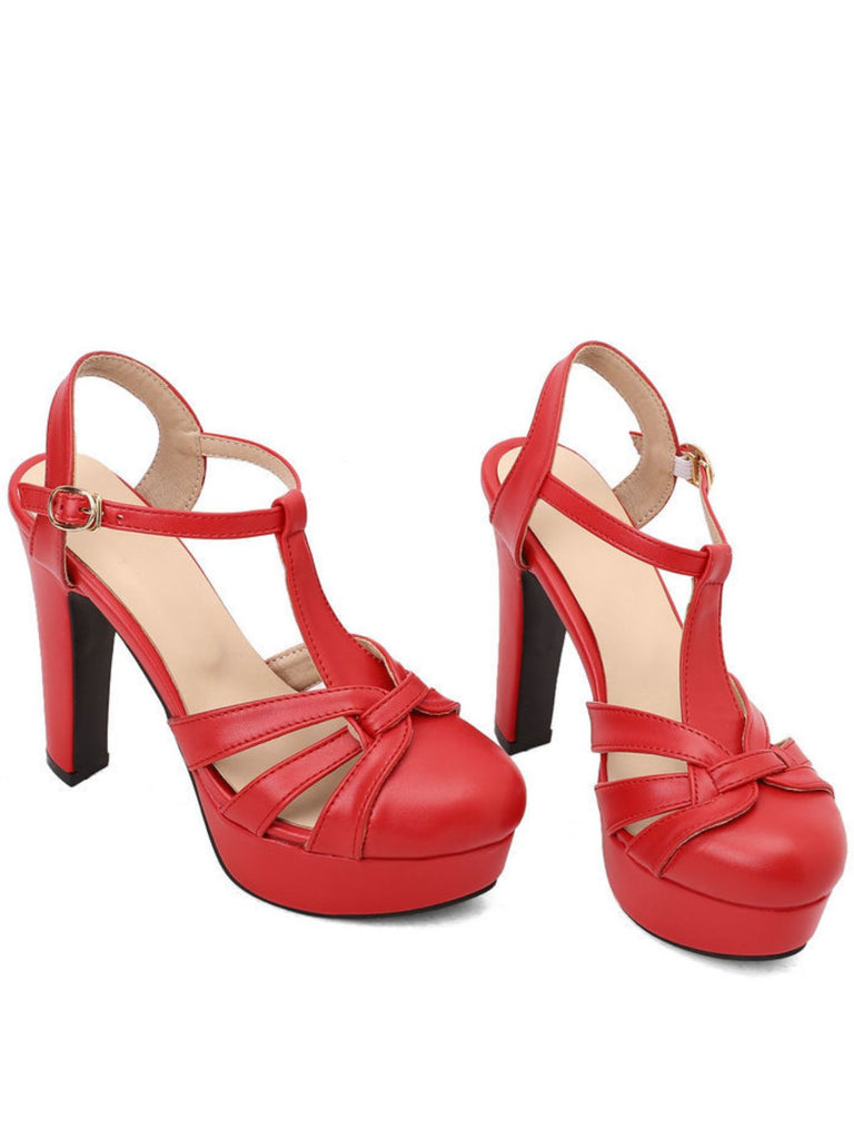 A pair of striking red high-heeled sandals designed with a classic T-strap and a sturdy platform.