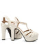 A pair of classic white high-heeled sandals with a supportive chunky heel and a comfortable T-strap closure.