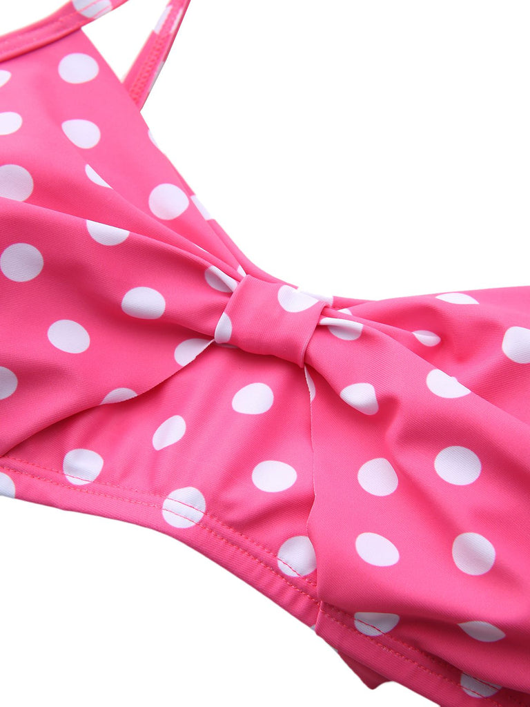 A detailed shot of the interior lining and edge stitching of the pink polka dot bikini top.