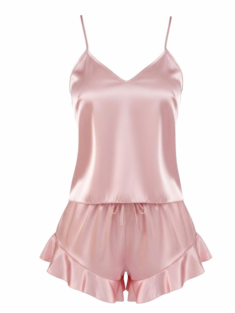 A dusty pink two-piece silky satin pajama set featuring a simple V-neck camisole top and matching shorts with a ruffled hem.