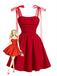 A vibrant red vintage-style fit and flare dress with sheer ribbon tie-shoulders and a ruched bodice, paired with a blonde pin-up illustration.