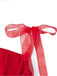Close-up of the delicate red sheer ribbon tied into a bow on the shoulder of the dress.