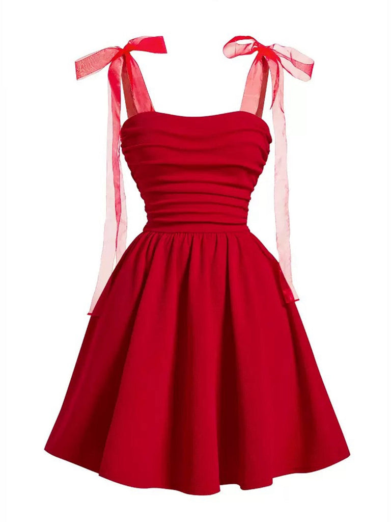 Front view of the sleeveless red party dress featuring a pleated bust and a voluminous A-line skirt.
