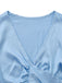 Close-up of the elegant deep V-neckline and smooth satin fabric of the light blue cropped lounge top