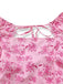 Close-up of the square neckline and delicate tie-back closure on the pink floral dress.