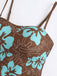 Close-up of the sweetheart neckline and thin adjustable shoulder straps on the brown floral swimsuit.