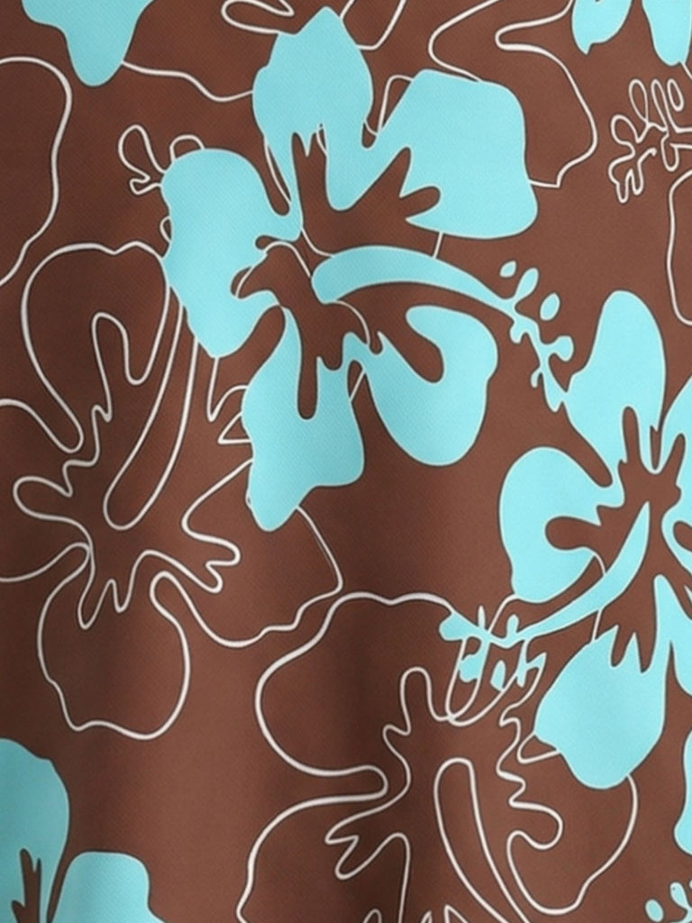 Macro shot of the fabric detail showcasing the turquoise hibiscus flowers and white line art foliage on a chocolate brown background.