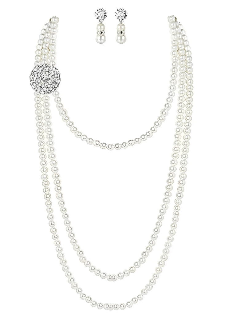 A vintage-inspired jewelry set featuring a multi-layer faux pearl strand necklace with a crystal brooch accent and matching pearl drop earrings.